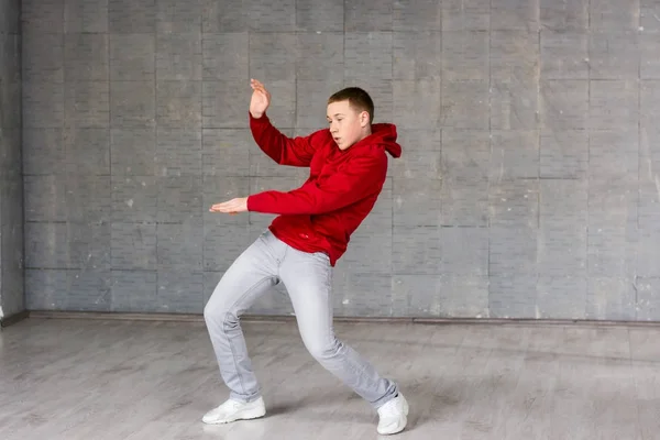 Cute young dancer posing on grey background. — Stock Photo, Image