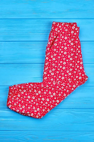 Red kids trousers in flowers print. — Stock Photo, Image