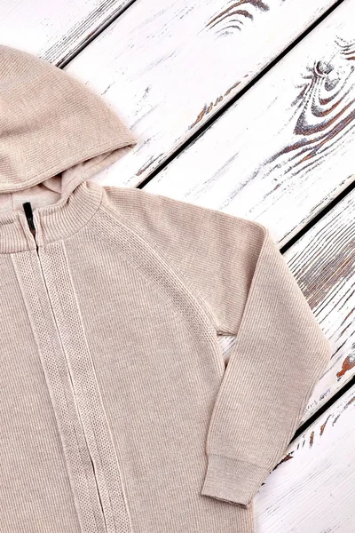 Kids beige knitted hooded jacket.