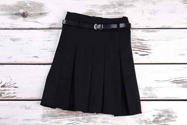 Pleated black uniform skirt.