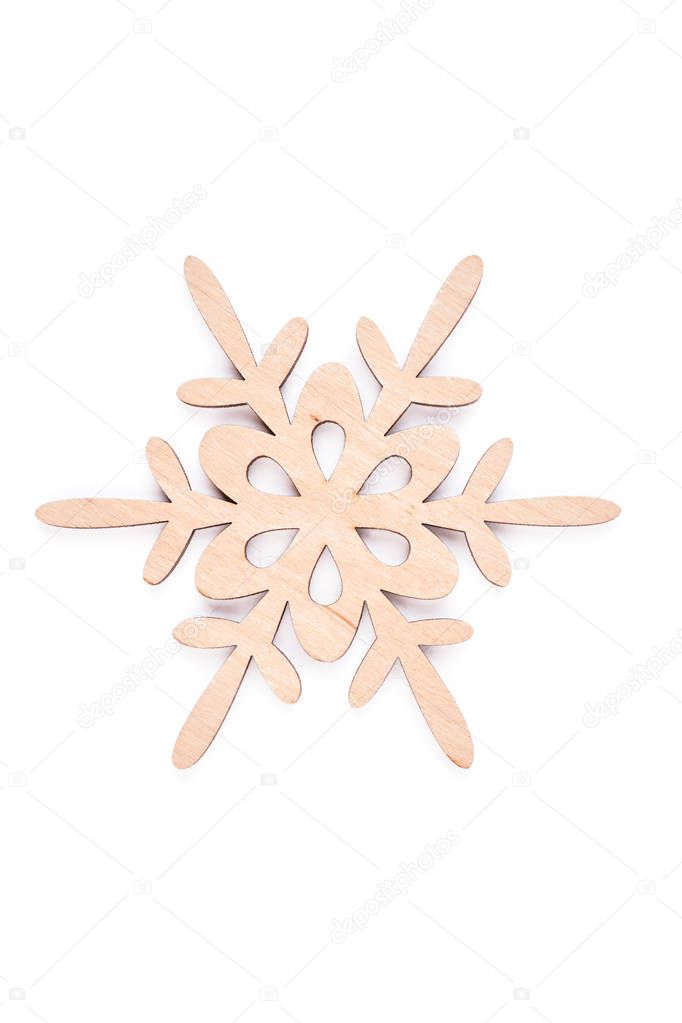 Wooden snowflake on white background.