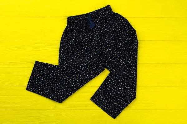 Floral pants on yellow rack — Stock Photo, Image