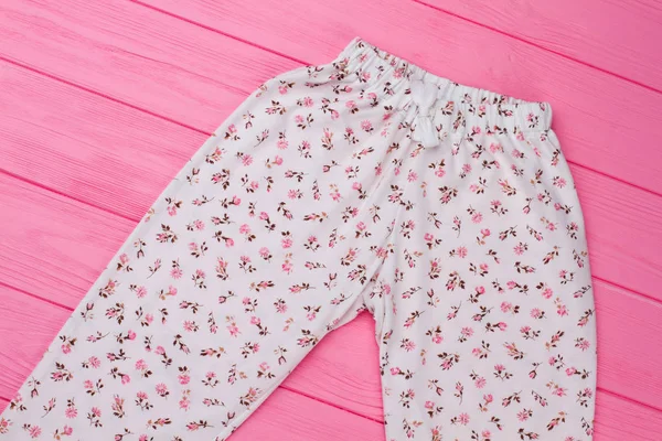 Girls pants on pink background