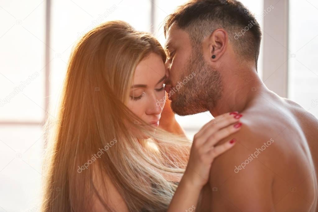 Sensual couple with eyes closed.