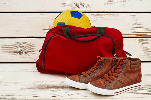 Sneakers, gym bag and ball