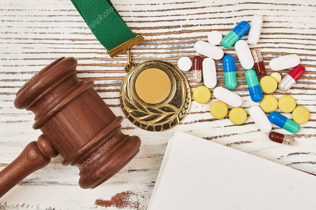 Judicial hammer, medal and pills
