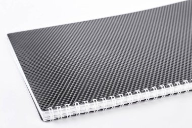 Siyah sarmal not defteri, beyaz arka plan.