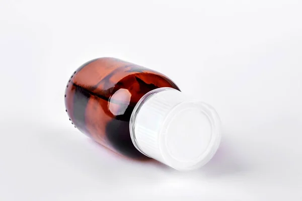 Bottle with medicine liquid, white background. — Stock Photo, Image