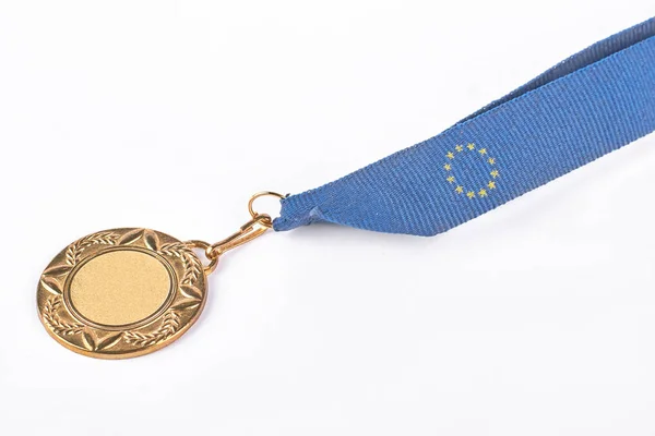 Golden medal on blue tape.