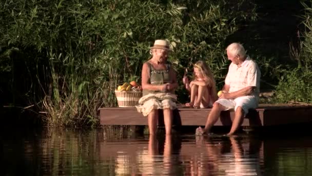 Grandparents and kid having fun outdoors. — Stock Video