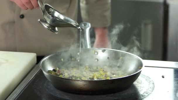 Sauce boat pouring onto hot pan, slow-mo. — Stock Video