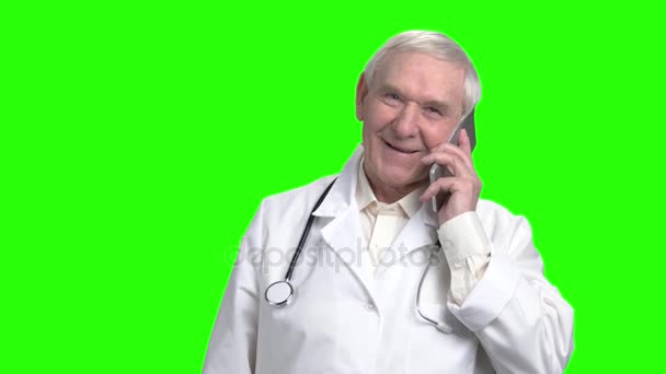 Cheerful senior doctor consulting a patient on the phone. — Stock Video