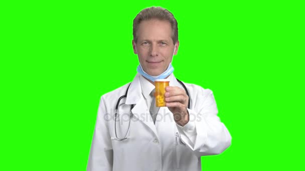 Mature doctor advertising can of pills. — Stock Video