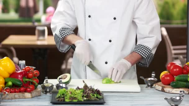 Chef-kok snijden avocado. — Stockvideo