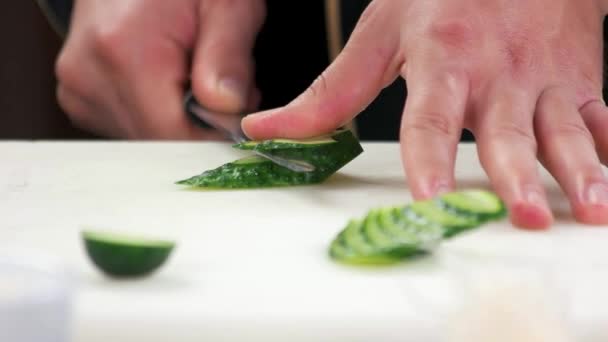 Hands cutting cucumber. — Stock Video