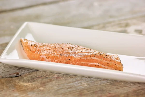 Raw salmon fillet with pepper.