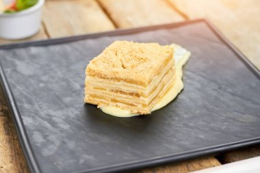 Napolyon pasta siyah kare plaka üzerinde.