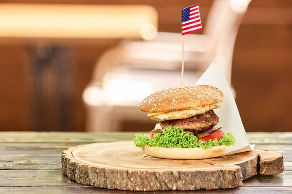 stock image Big hamburger with sticking out american flag.