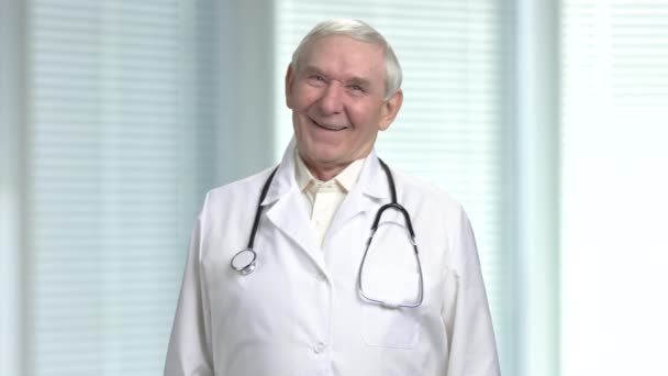 Old male doctor laugh at your jokes. — Stock Video