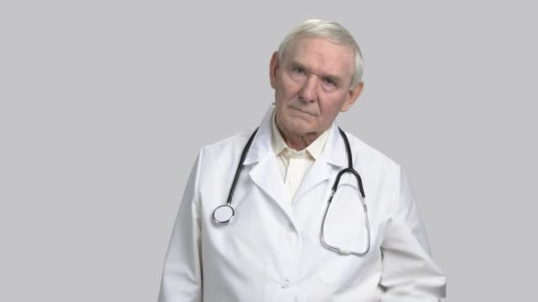 Portret van ernstige somber gezicht van een oude dokter. — Stockvideo