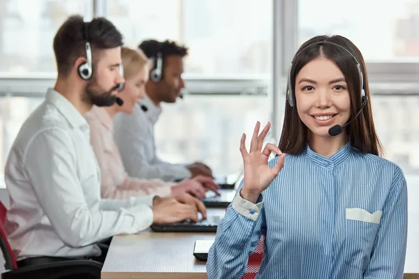 Call center operator with okay hand sign gesture. — Stock Photo, Image
