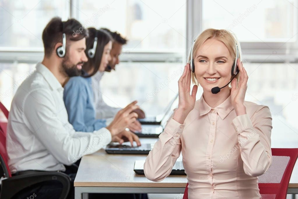 Call center service operator listening to headset.