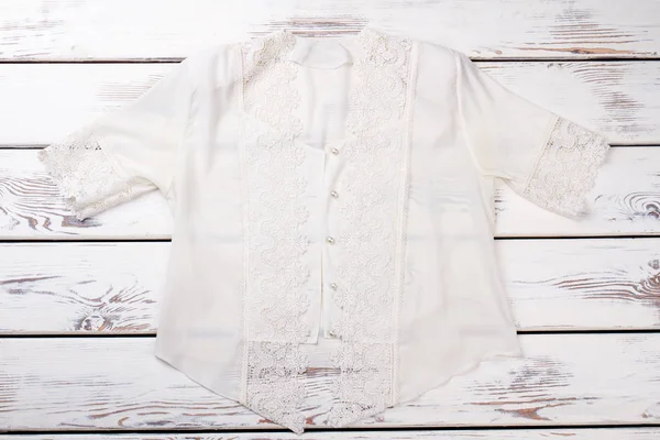 Female white silk blouse with lace.