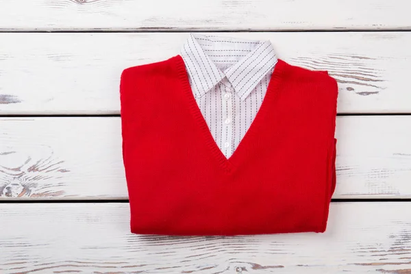 Female red sweater with white collar.