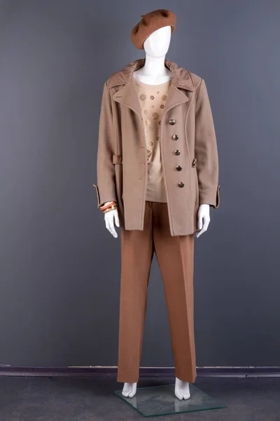 Women stylish beige top coat on mannequin.