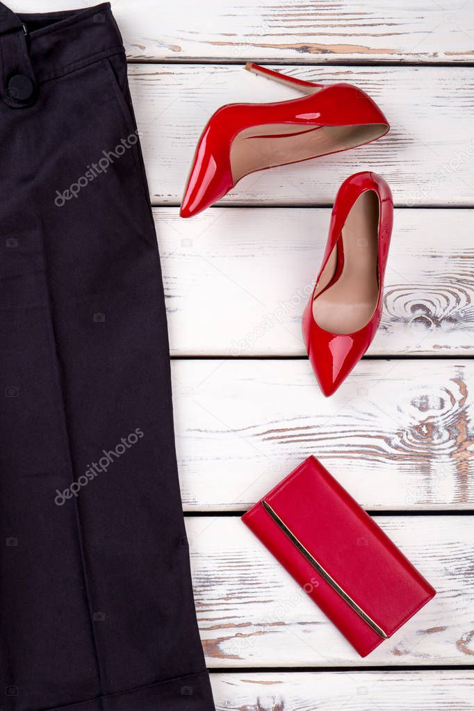 Women red heels and purse, top view.