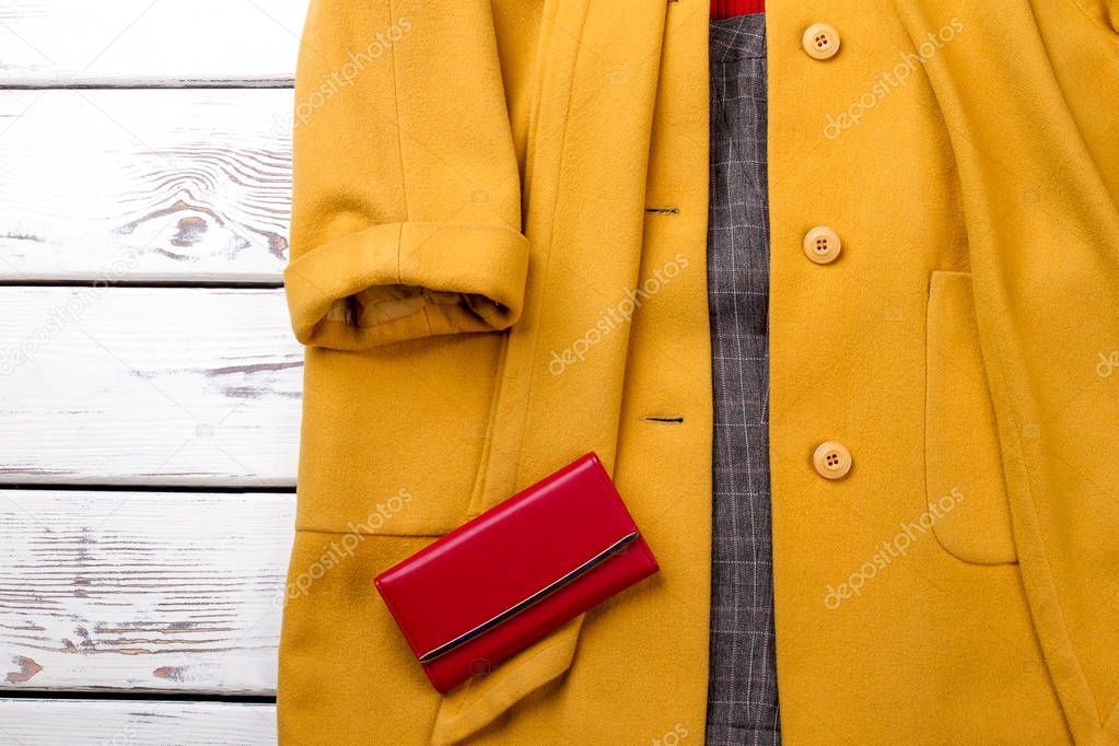 Female cashmere overcoat of yellow color.