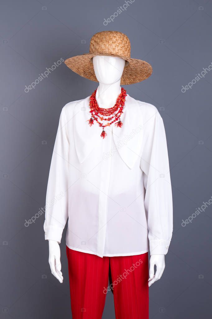 Straw hat, white blouse and necklace.