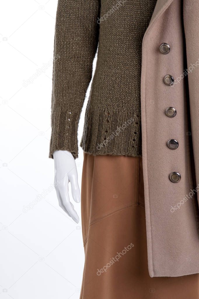 Pullover, skirt, overcoat close up.