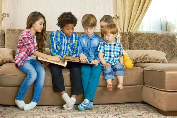 Kids reading a book indoors. — Stock Photo, Image