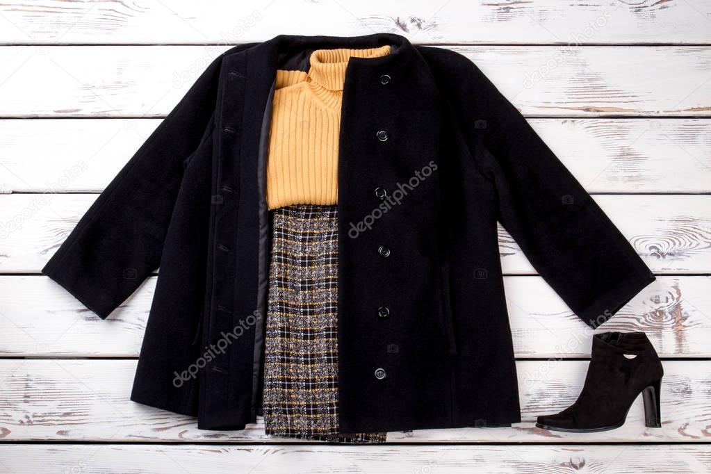 Winter women outfit with yellow woolen sweater.