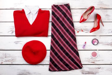 Ahşap arka plan üzerinde kırmızı Bayan kış giysileri bakmak.