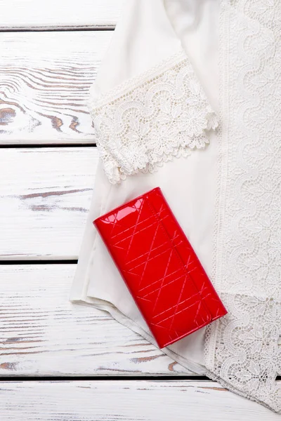 White lace blouse and red wallet, close up. — Stock Photo, Image