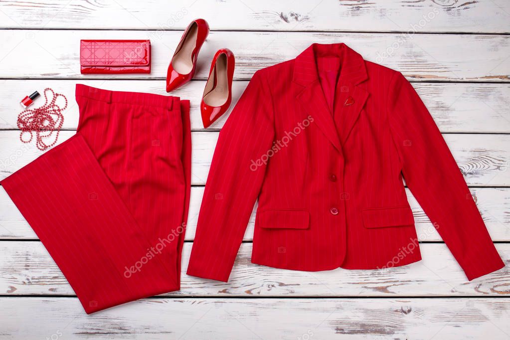 Flat lay red women suit and accessories.