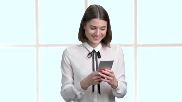 Красива жінка використовує свій смартфон в офісі . — стокове відео