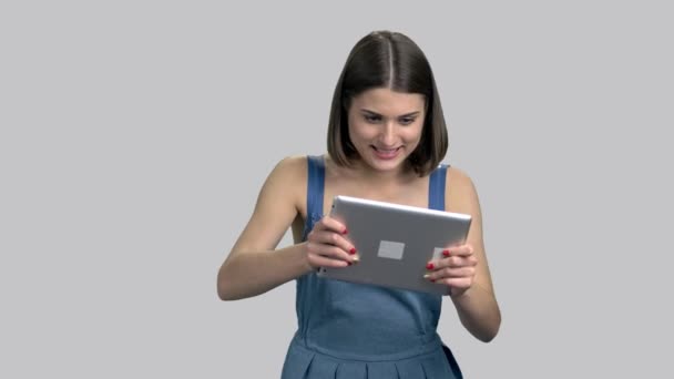 Joyful girl playing on pc tablet. — Stock Video