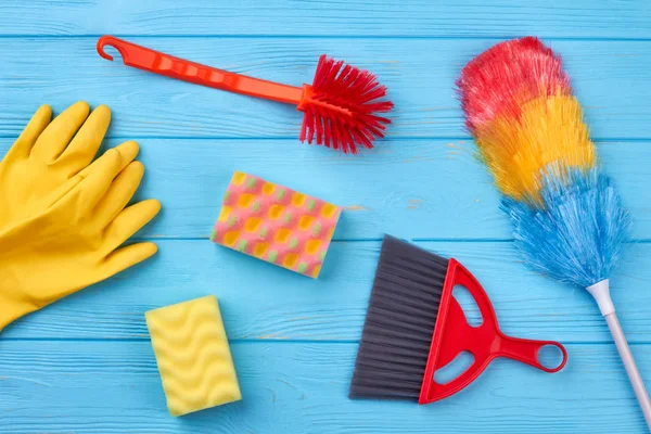 Collection of cleaning supplies on blue background. — Stock Photo, Image