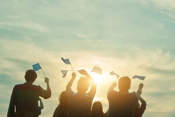 People raising european union flags in the air.