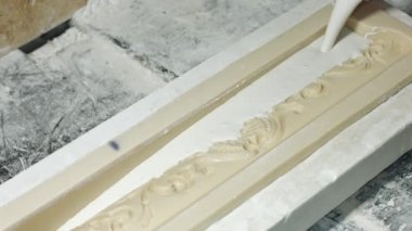 Adam dökülen sıvı alçı kalıp içinde.