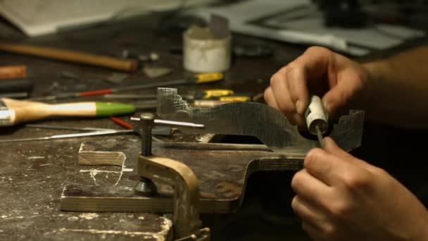 Craftsman working with metal detail. — Stock Video