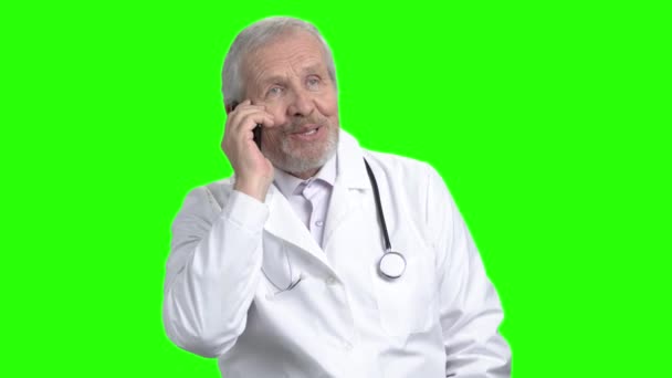 Expressive old doctor speaking on phone. — Stock Video