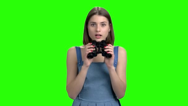 Portrait of a young woman looking through binoculars. — Stock Video