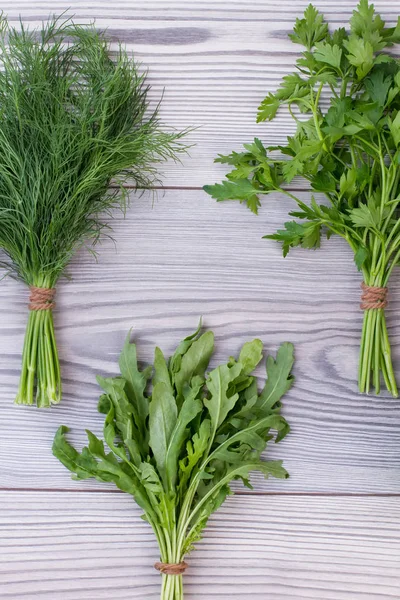 Mixed green herbs on wooden background.