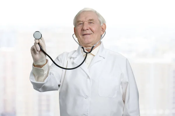 Doctor listening to heart with stethoscope.
