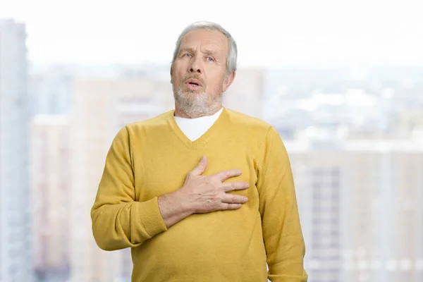 Portrait of old grandpa touching his chest. — Stock Photo, Image