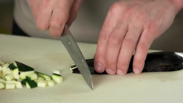 Hands chopping aubergine. — Stock Video